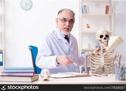 The aged male doctor with skeleton. Aged male doctor with skeleton