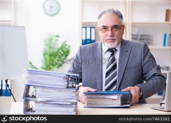 The aged male employee unhappy with excessive work . Aged male employee unhappy with excessive work 