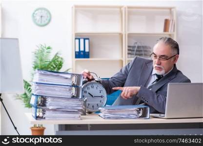 The aged male employee unhappy with excessive work . Aged male employee unhappy with excessive work 