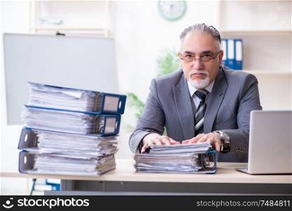 The aged male employee unhappy with excessive work . Aged male employee unhappy with excessive work
