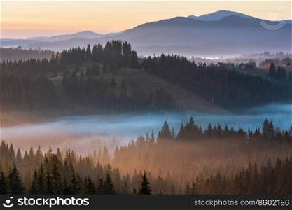 The air. Early morning fog over the autumn slopes of Carpathian Mountains  Yablunytsia village and pass, Ivano-Frankivsk oblast, Ukraine .