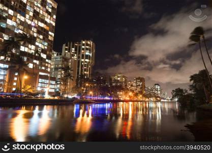 The Ala Wai Canal is smoooth at night along the Kapahulu at night