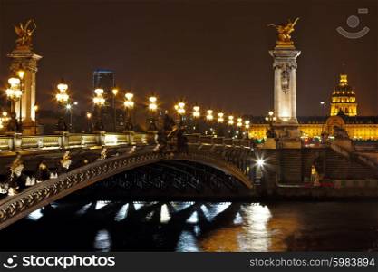 The Alexander III Bridge across river Seine at night in Paris, France