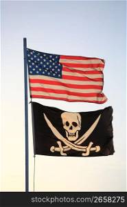 The American flag and pirate flag flying from flagpole