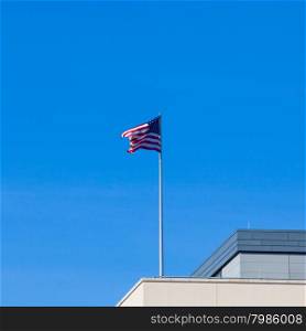 the American flag on top of the US Embassy in Berlin.