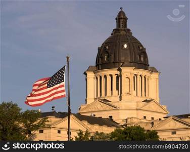 The American Flag waves in front of the capitol dome in Pierre, SD