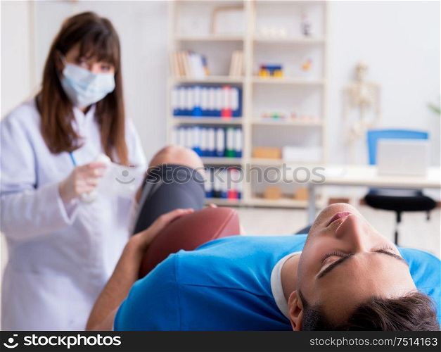 The american football player with injury visiting doctor. American football player with injury visiting doctor