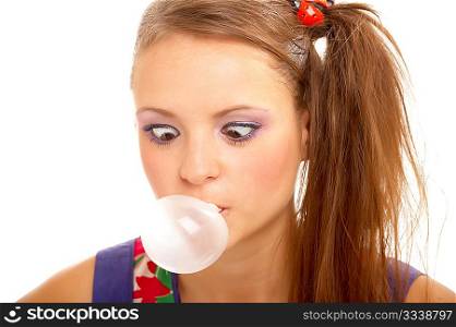The amusing girl has become cross-eyed, looking on the inflated bubble, on a white background