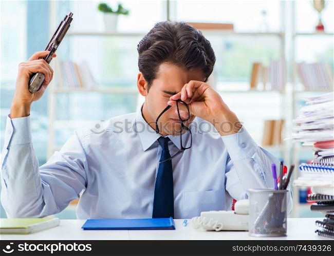 The angry businessman with gun thinking of committing suicide. Angry businessman with gun thinking of committing suicide