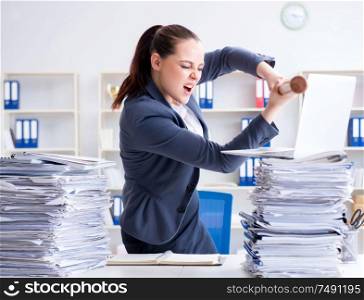 The angry businesswoman with baseball bat in office. Angry businesswoman with baseball bat in office