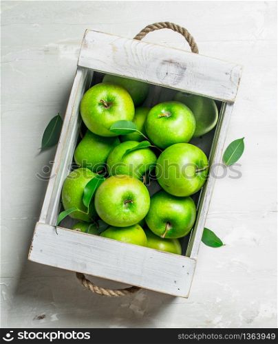 The apples in the box. On white rustic background .. The apples in the box.