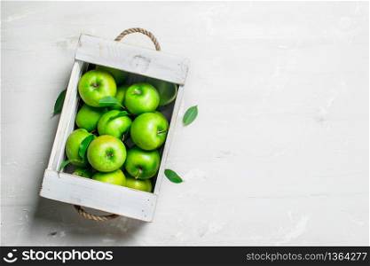 The apples in the box. On white rustic background .. The apples in the box.