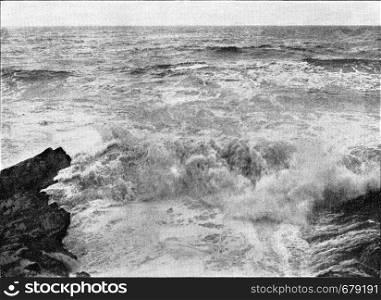 The approach of the waves by rough seas, vintage engraved illustration. From the Universe and Humanity, 1910.