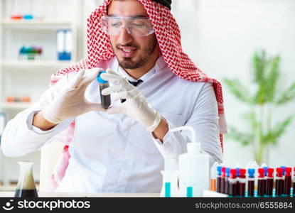 The arab chemist scientist testing quality of oil petrol. Arab chemist scientist testing quality of oil petrol
