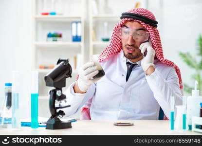 The arab chemist scientist testing quality of oil petrol. Arab chemist scientist testing quality of oil petrol