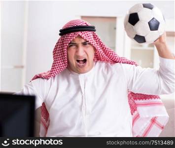 The arab man watching tv at home. Arab man watching tv at home