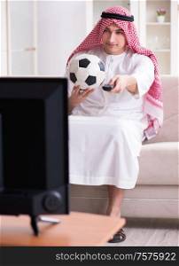 The arab man watching tv at home. Arab man watching tv at home