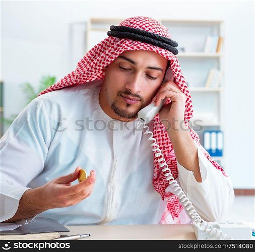 The arab man with bitcoin in cryptocurrency mining concept. Arab man with bitcoin in cryptocurrency mining concept