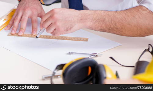 The architect working in his studio on new project. Architect working in his studio on new project