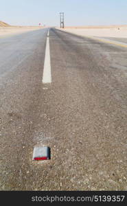 the asphalt empry street and loneliness in oman near the old desert