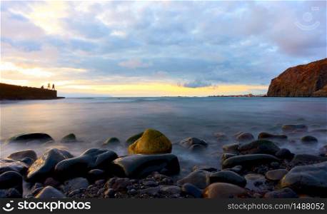 The Atlantic ocean and stones on the beach at sunset in Tenerife island, The Canaries - Long exposition