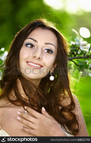 The attractive young girl in greens of trees