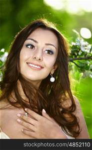 The attractive young girl in greens of trees