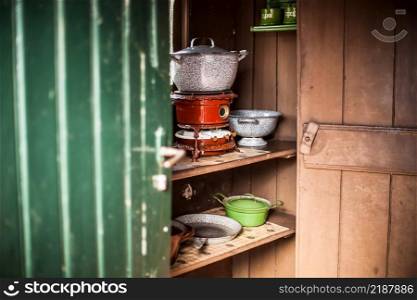 . The authentic kitchen utensils. Vintage kettle and old kerosene stove.. Old vintage oil stoves fired on using paraffin in an authentic kitchen with atributes. 