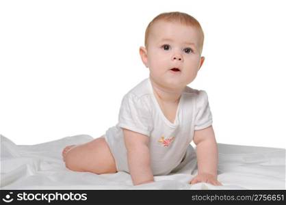 The baby on a bedsheet. Age of 8 months. It is isolated on a white background