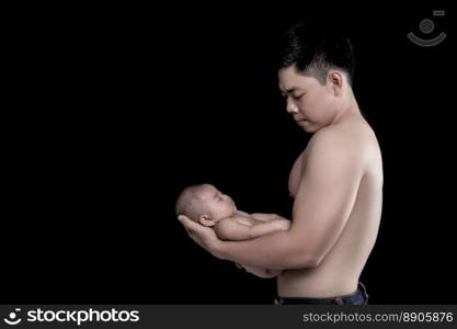 The baby s≤eps in the hands of a strong father.