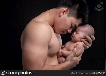 The baby s≤eps in the hands of a strong father.
