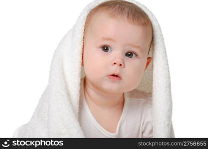 The baby under a towel. Age of 8 months. It is isolated on a white background