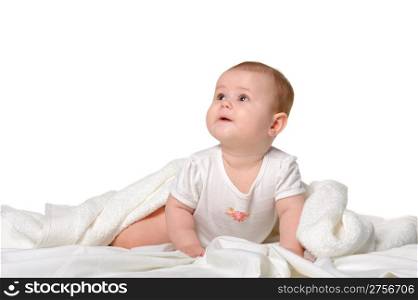 The baby under a towel. Age of 8 months. It is isolated on a white background