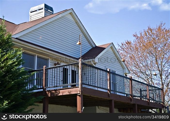 The back deck area of a home, with metal railing.