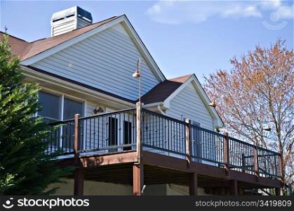 The back deck area of a home, with metal railing.