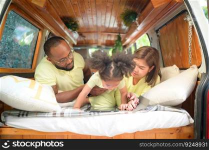The back of a white classic van, little kids play and learn about the world on their tablet with parents taking care of helping.