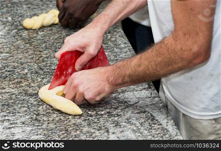the baker prepares a bread dough