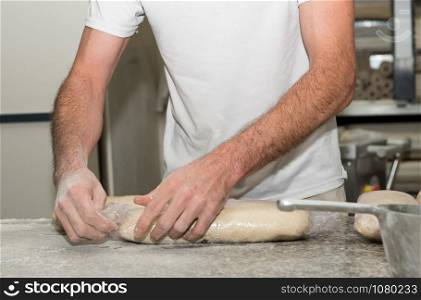 the baker prepares bread dough