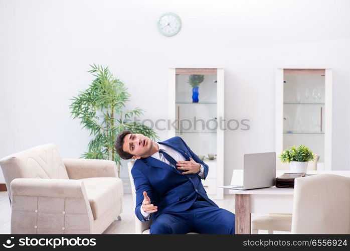 The bankrupt businessman having heart attack at home. Bankrupt businessman having heart attack at home. The bankrupt businessman having heart attack at home