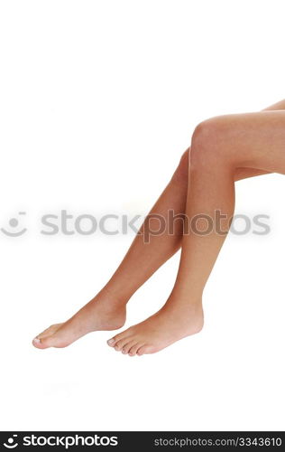 The bare legs of a young woman with bare feet on white background.