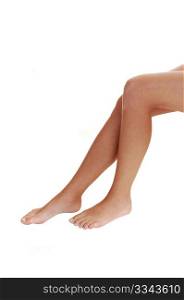 The bare legs of a young woman with bare feet on white background.