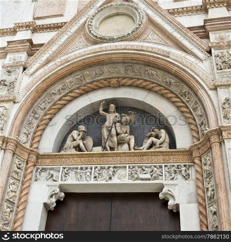 The Basilica of San Petronio is the main church of Bologna, Italy. Detail of the lunette above the entrance left side door.