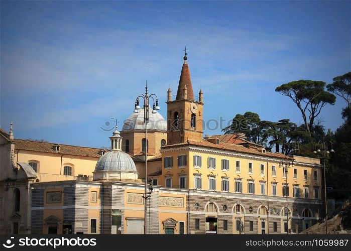 The Basilica of Santa Maria del Popolo in Rome, Italy. It stands on the north side of Piazza del Popolo, one of the most famous squares in the city .. The Basilica of Santa Maria del Popolo in Rome, Italy. It stands on the north side of Piazza del Popolo, one of the most famous squares in the city