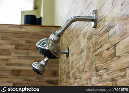 The Bath shower head on the stone wall