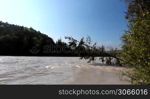 the bavarian river Lech with a strong flow and some inundation