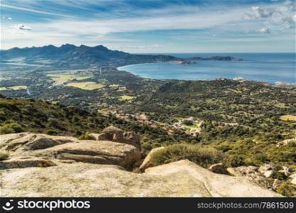 The bay of Calvi with blue skies and maquis in the foreground