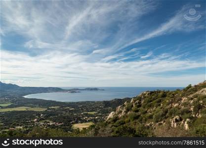 The bay of Calvi with blue skies, the mediterranean and maquis in the foreground