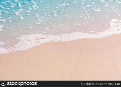 The beach and sand with the blue water and foaming wave in the tropical beach in Thailand
