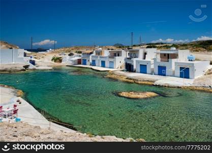 The beach of Agios Konstantinos with crystal clear turquoise water and traditional greek white houses. Milos island, Greece. The beach of Agios Konstantinos in Milos, Greece