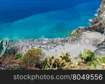 The beach with stone pebbles in the village of Vernazza. Cinque Terre National Park, Liguria, Italy.